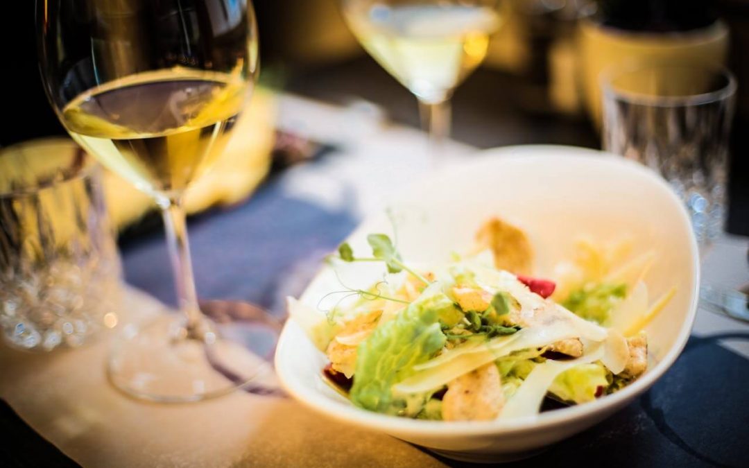 Salad with vegetables and herbs paired with while wine