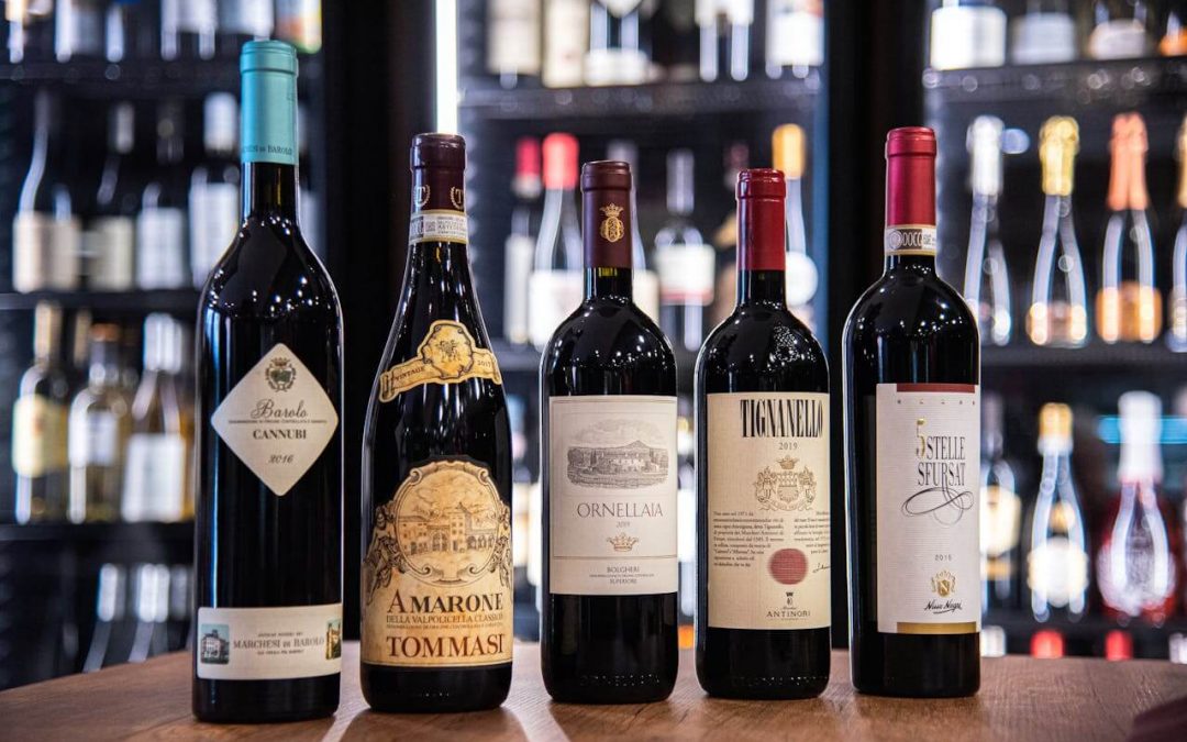 A group of six bottles of Italian wines sitting on a table.